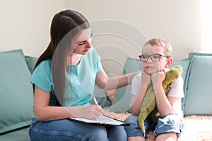 Psychologist listens to a small child during a therapy session