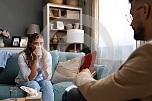 Psychologist man doctor making notes consulting female patient in bright office mental health care concept. Psychotherapist