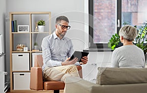 Psychologist with tablet pc and senior patient