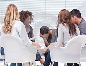 Psychologist taking notes while woman crying