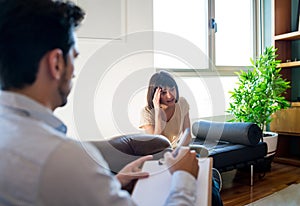 Psychologist talking with patient on therapy session.