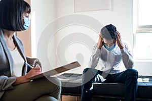 Psychologist talking with patient on therapy session.