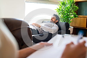 Psychologist talking with patient on therapy session.