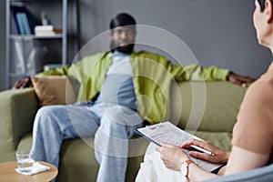 Psychologist talking to patient in office