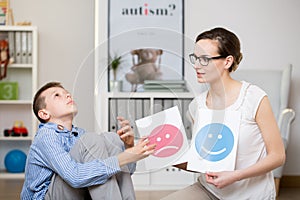 Psychologist working with autistic boy photo