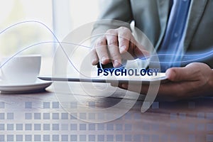 Psychologist working with modern tablet at table in office, closeup