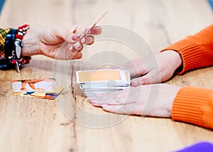 The psychologist works with metaphorical cards with the client at the desk