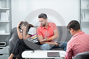 Psychologist with young couple, psychotherapist or marriage counselor listen mental health of couple. Psychological