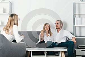 Psychologist with young couple, psychotherapist or marriage counselor listen mental health of couple. Psychological