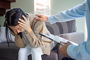 Psychologists or doctors treat psychological symptoms, touch the shoulder of female patients with stress and depression.