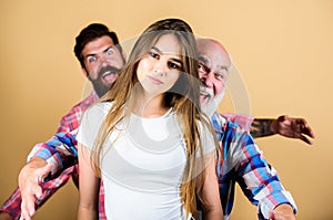 Psychology anxiety. two bearded men scare and chase young woman. family values. generation and gender concept