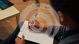 Psychology counselor taking notes on clipboard at therapy session