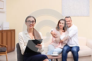 Psychotherapist and happy couple having meeting. Family counselling