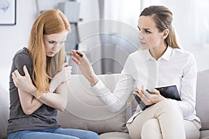 Psychotherapist reassuring teenager with problem