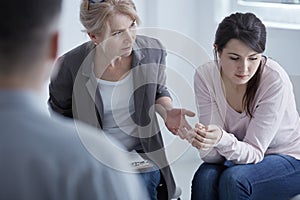 Psychotherapist supporting young woman