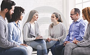 Psychotherapist talking with patients at support group meeting