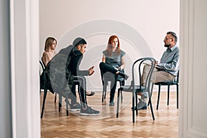 Psychotherapist talking to rebellious teenagers with alcohol add photo