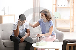 Psychotherapist working with African-American teenage boy