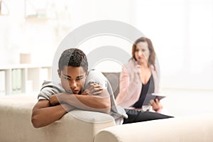Psychotherapist working with teenage African-American boy