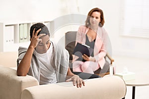 Psychotherapist working with teenage African-American boy