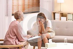 Psychotherapist working with teenage girl