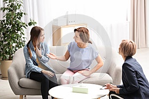 Psychotherapist working with teenage girl and her mother