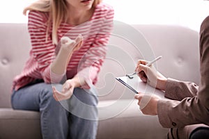 Psychotherapist working with woman in office