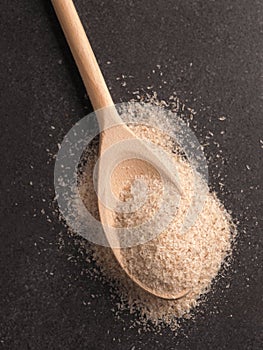 Psyllium husks on a wooden spoon