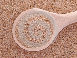 Psyllium seeds husks in wooden spoon