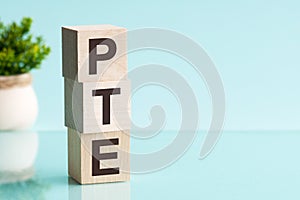 PTE - acronym from wooden blocks with letters, Pearson Tests of English PTE concept Foreign Language exams