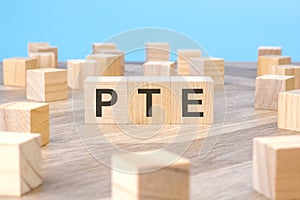 PTE text as symbol on cube wooden blocks.