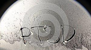 PTSD concept word on frosty window background photo