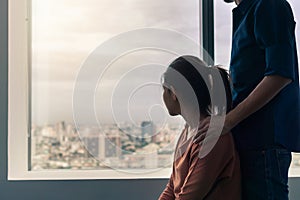 PTSD Mental health concept, Psychologist sitting and touch young depressed asian woman for encouragement near window with low photo