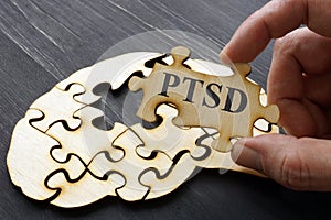 PTSD Post Traumatic Stress written on the puzzle photo