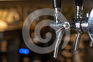 Pub Interior With Taps of Draft Beer. Taps of draft beer inside a sports bar