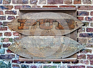 Pub Wooden sign hanged on colorful brick wall background