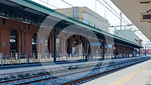 Public accessible platforms at Brindisi train station, Platform and train track visible on this quite empty train station in early