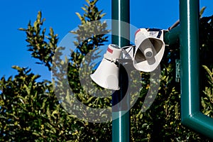 Public address bullhorn outdoor speakers on a green