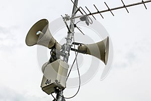 Public address system speakers on a pole, antenna and box with n