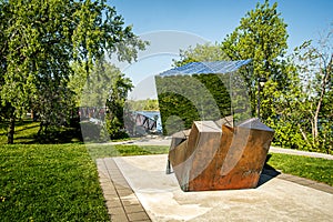 Public Art sculpture before a little bridge in a Verdun park borough of Montreal