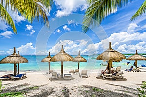 Public beach with lounge chairs and umbrellas, Mauritius island, Africa