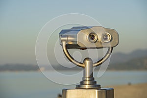 Public binocular on sea shore, close up