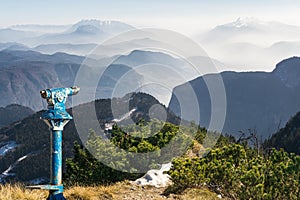 Public binoculars and Mountain Silhouettes at Sunrise. Foresight and vision for new business concepts and creative ideas photo
