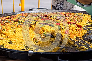 Public celebration or fest in Spain. Large fla frying pan with cooked paella. Selling to guests.