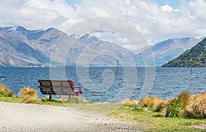 The public chair at the edge of Queenstown garden with spectacular view of lake Wakatipu in Queenstown, New Zealand.