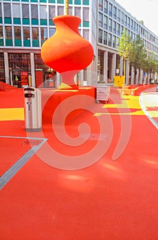 The Public City Lounge is in the open air covered in red rubber granulate and lit by artistic lighting elements in St. Gallen