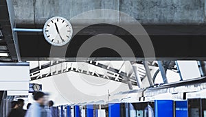 Public clock in railway station at the hanging with roof of subway central train station. It is clock for watch time waiting