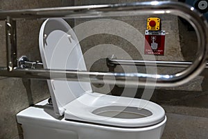 Public disabled toilet in a large building. Modern restroom for disabled people. Inside disable toilet or elderly people.