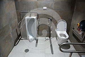 Public disabled toilet in a large building. Modern restroom for disabled people. Inside disable toilet or elderly people.