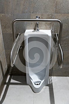 Public disabled toilet in a large building. Modern restroom for disabled people. Inside disable toilet or elderly people.